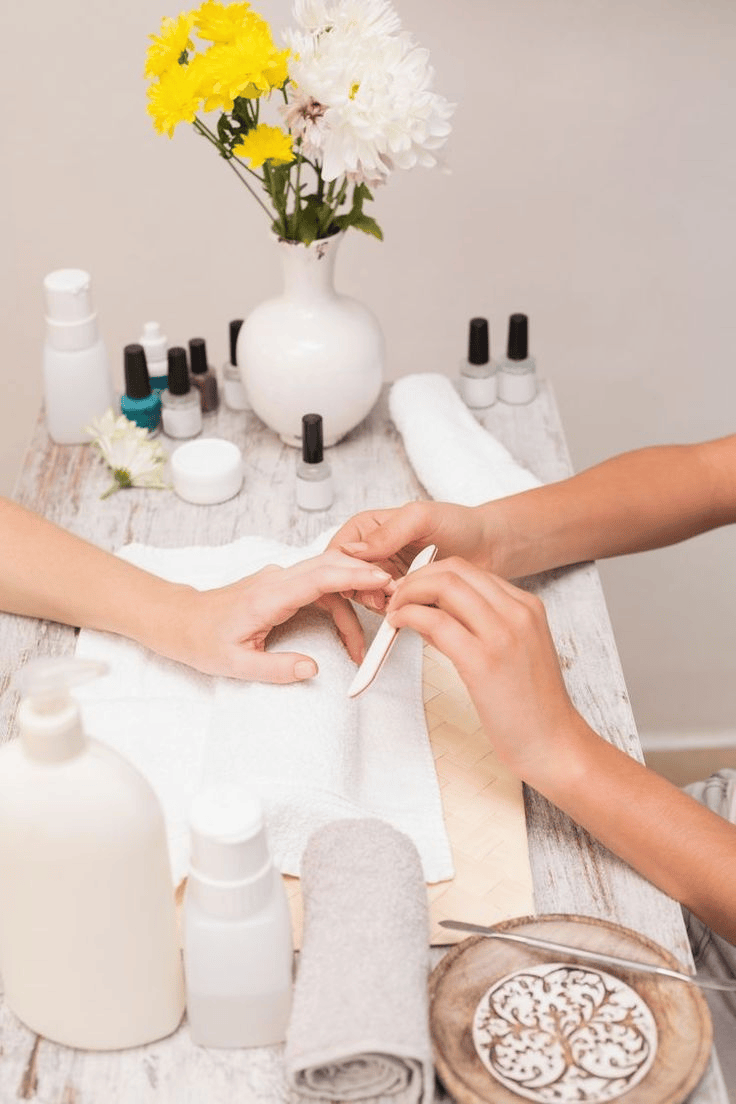 A woman enjoying a nail service at a salon