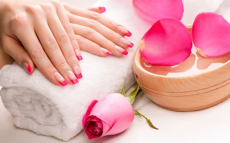 A french tip design nails with pink roses.